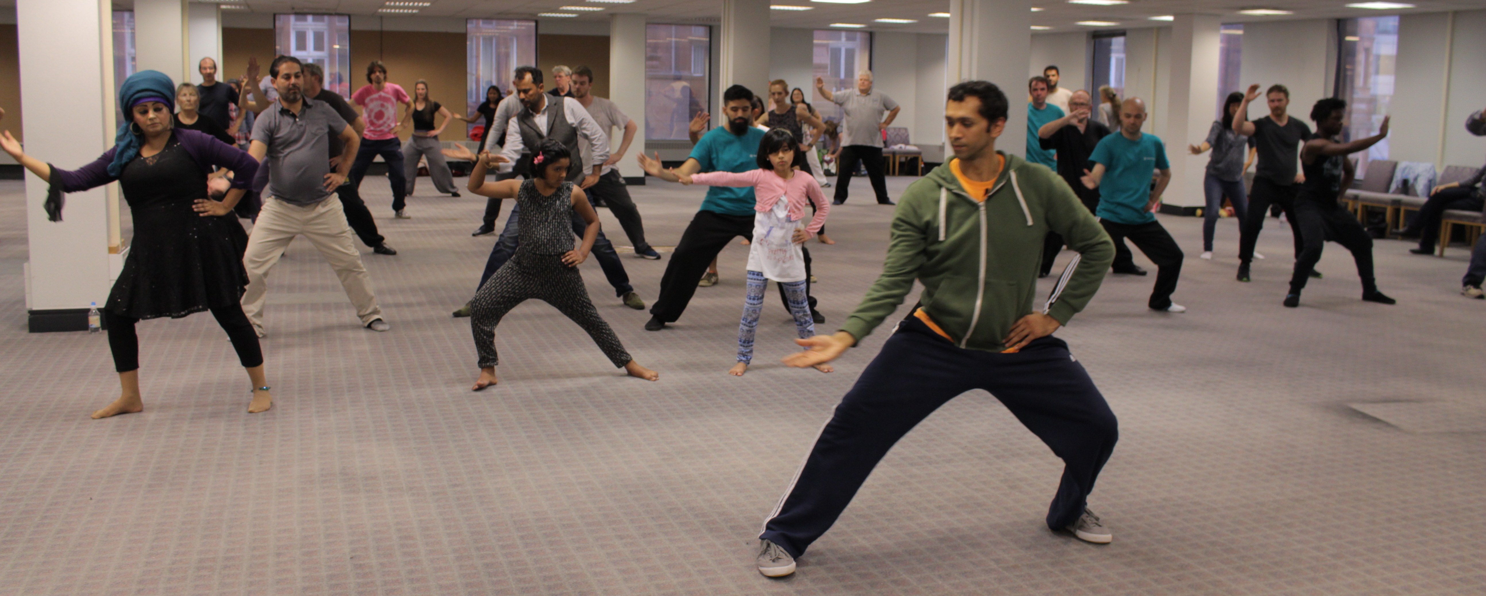 A photo of Aamir conducting a silk reeling demonstration